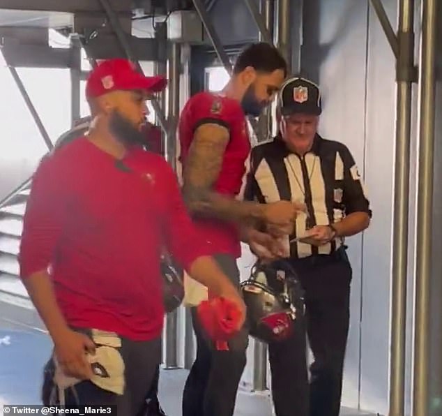 A reporter in the Bank of America Stadium tunnel in Charlotte spotted officials looking for Mike Evans to sign something for them